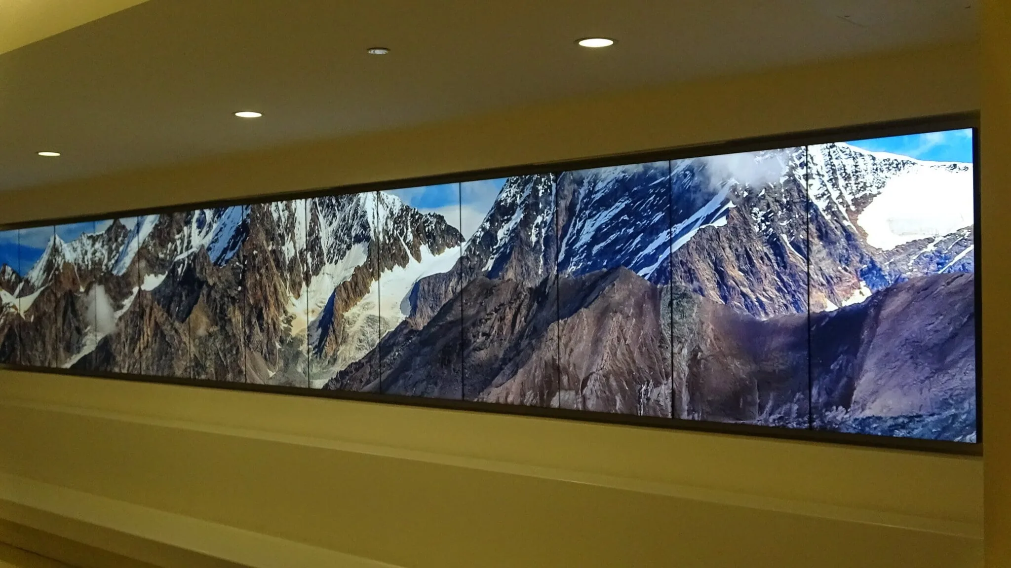 Panoramic mountain landscape on wall display.