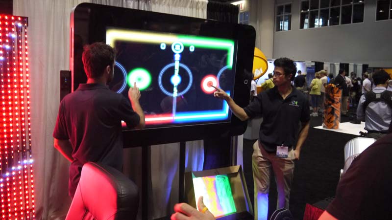 Playing glow hockey on a giant iPhone at IAAPA 2017