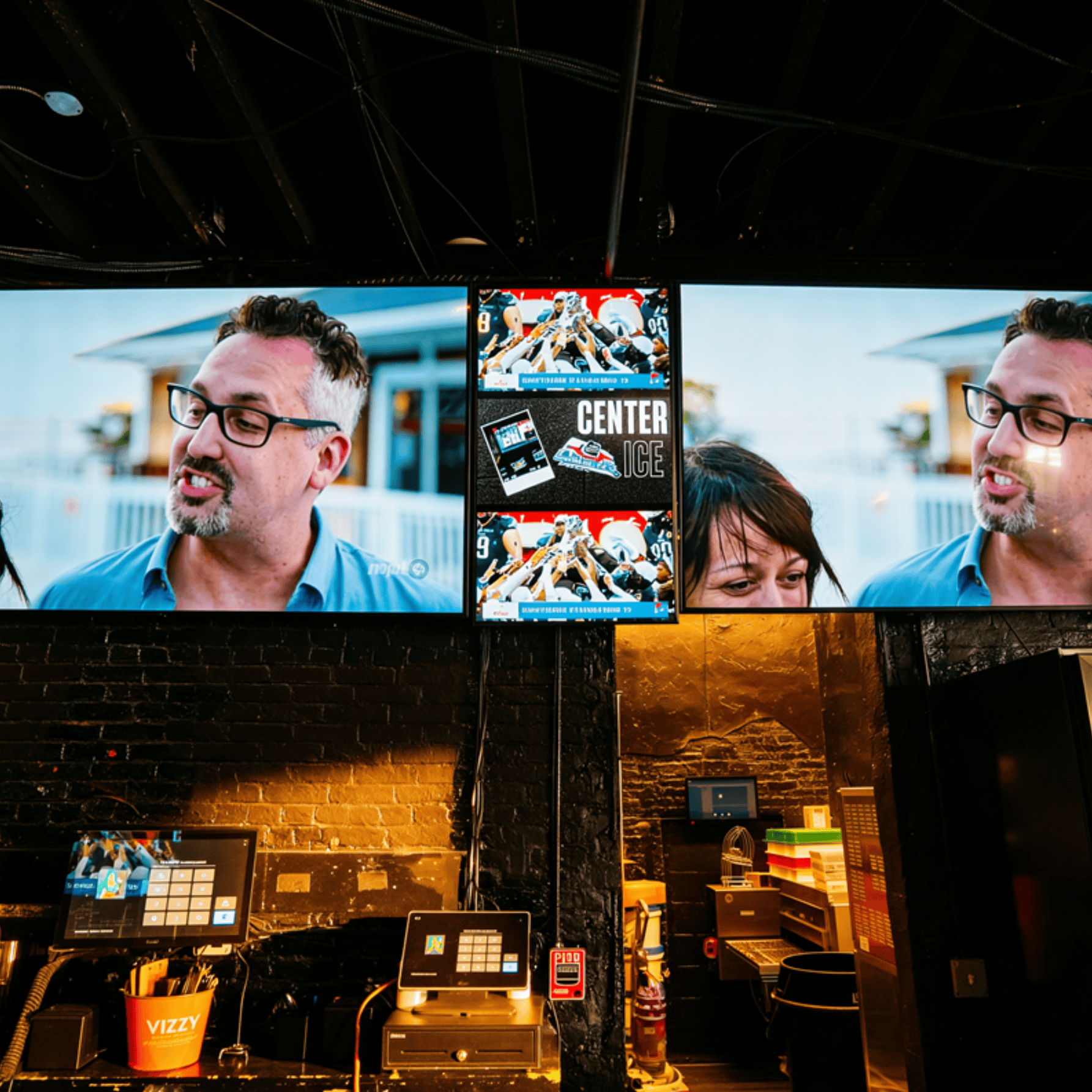 Two screens display sports and conversation.