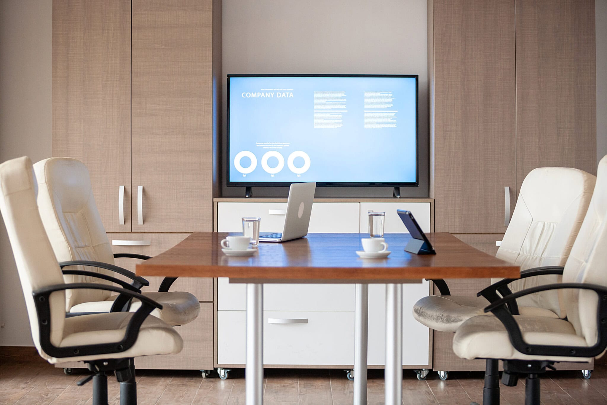 empty business meeting conference room with graphs and diagrams on tv