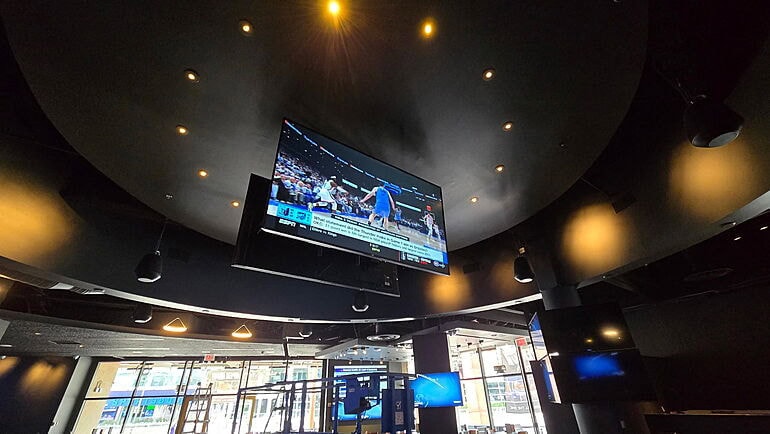 Sports game on TV in modern bar.