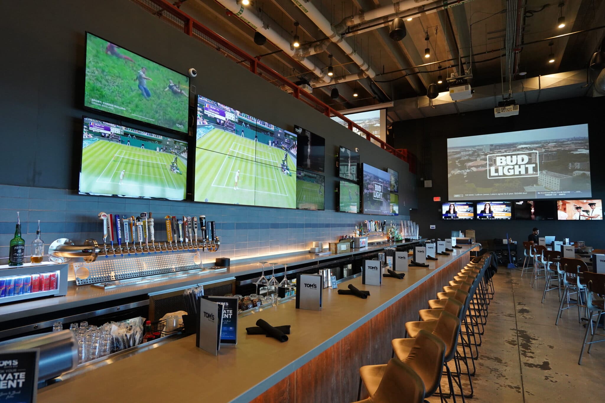 Sports bar interior with multiple TV screens.