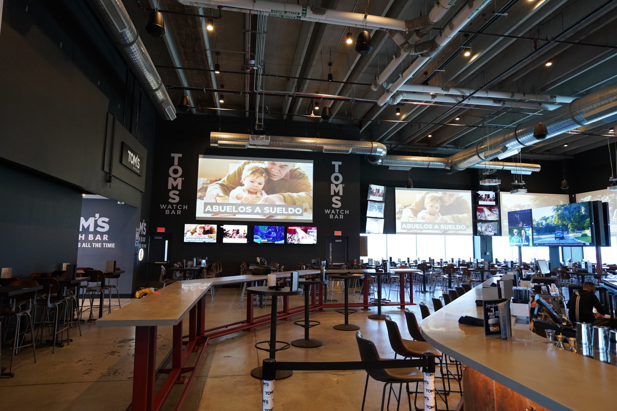 Tom's Watch Bar interior with large screens and seating