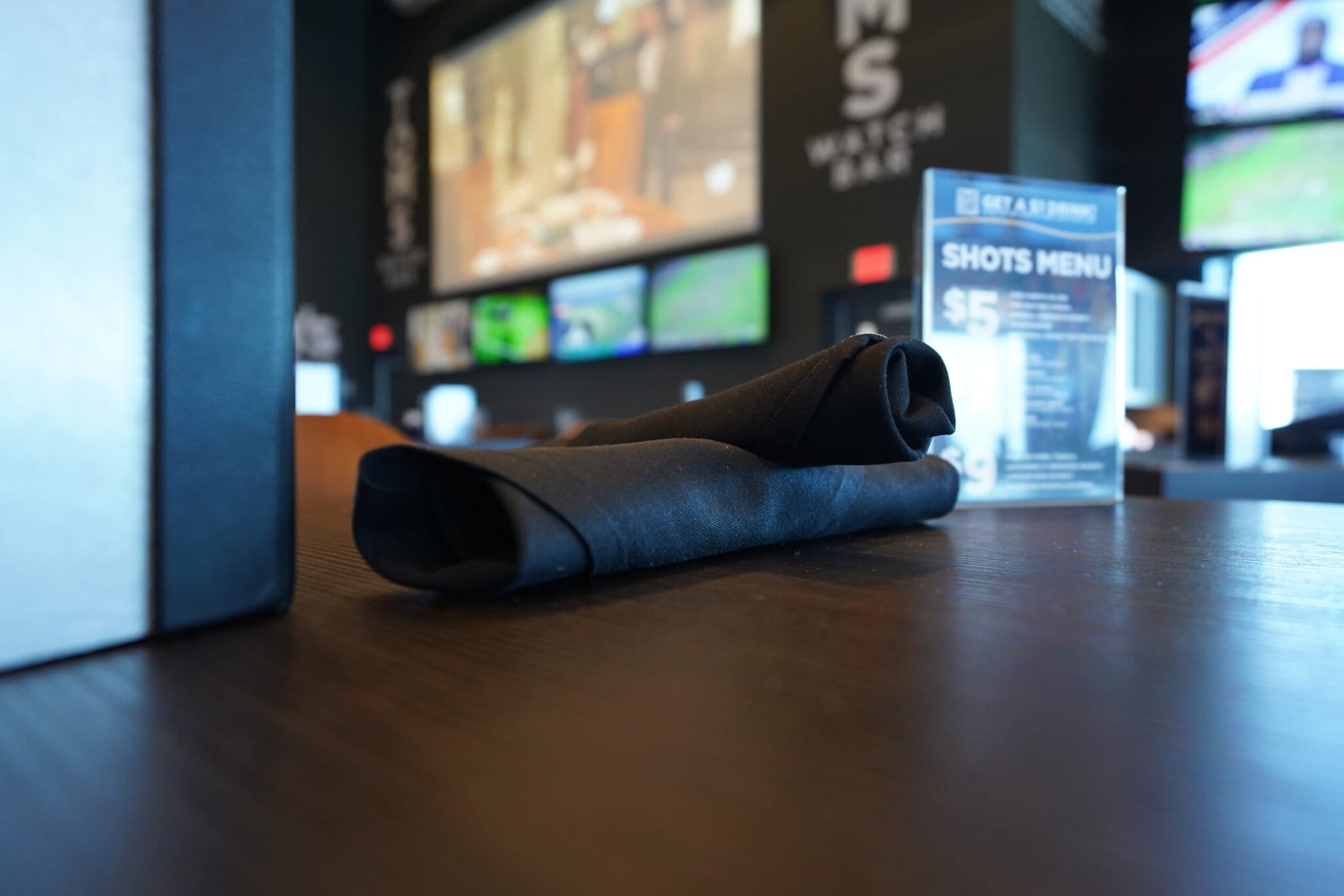 Folded napkins and menu on wooden table