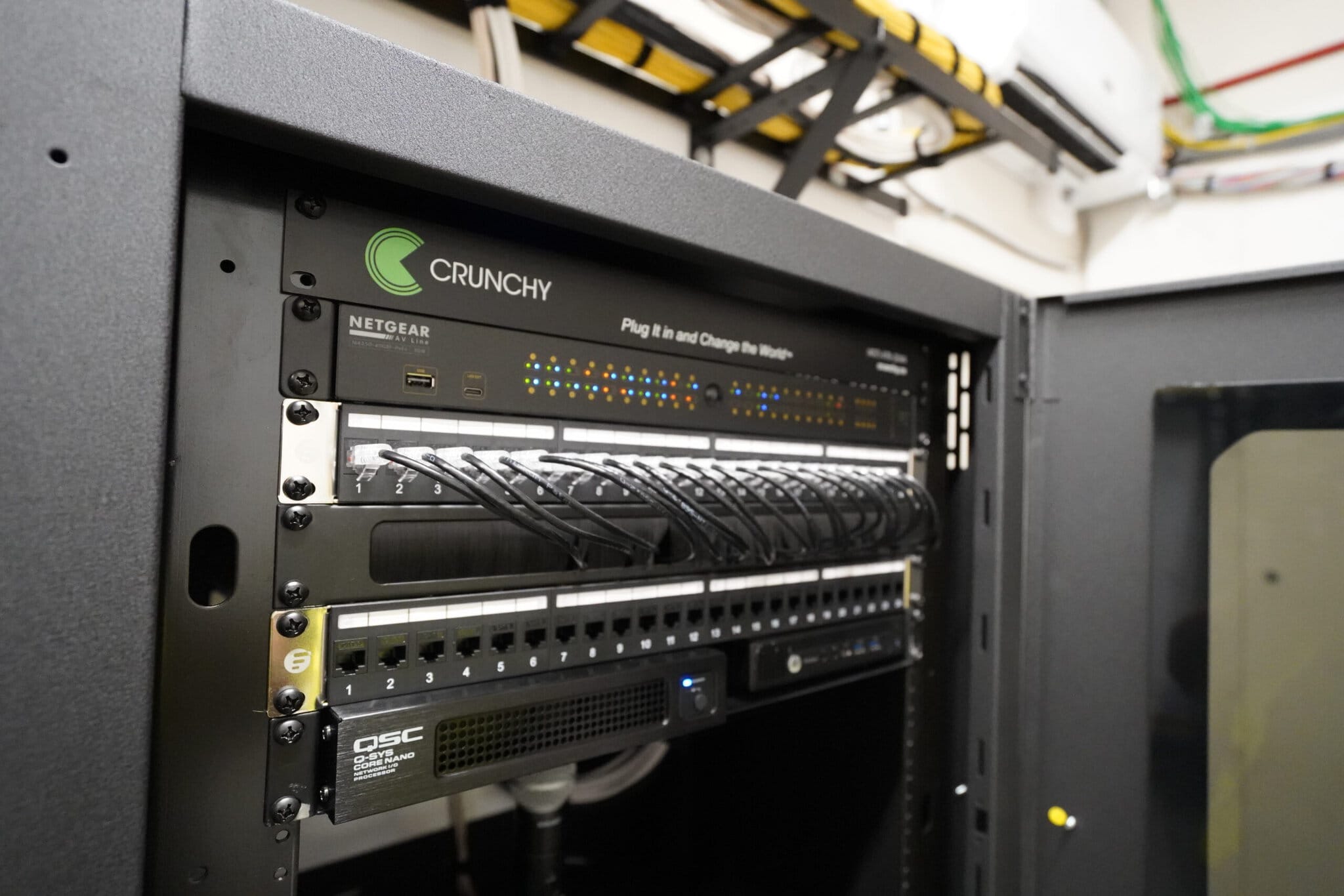 Server rack with network equipment and cables.