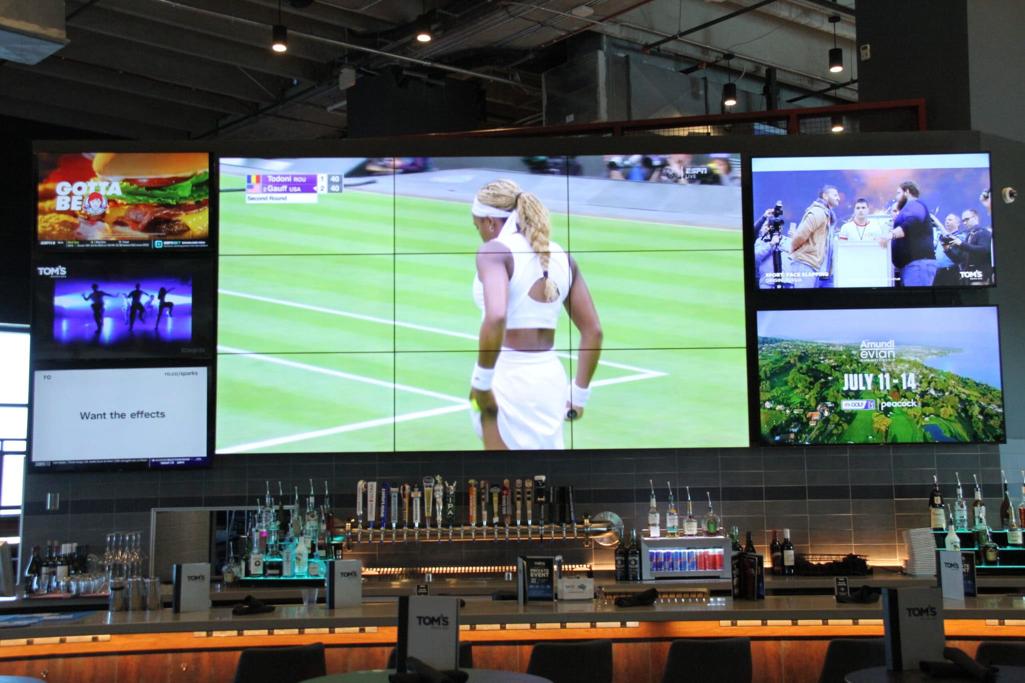 Sports bar system with multiple TV screens showing tennis.