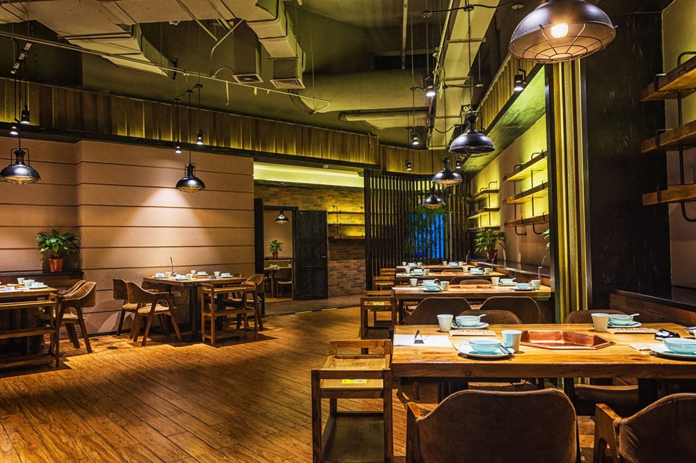 Cozy restaurant interior with wooden tables and chairs.