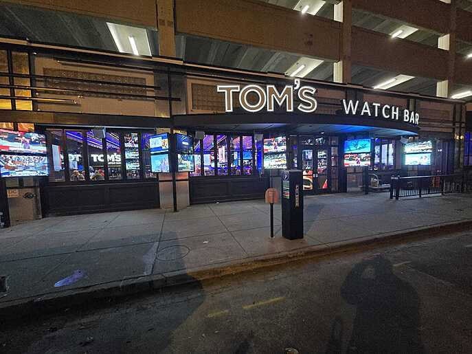 Toms Watch Bar audiovisual at night in Indianapolis, IN