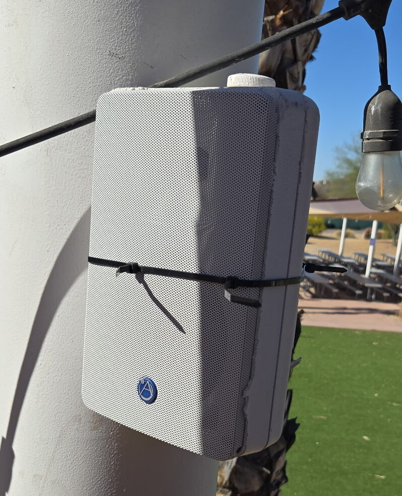 Outdoor speaker on pole with string lights