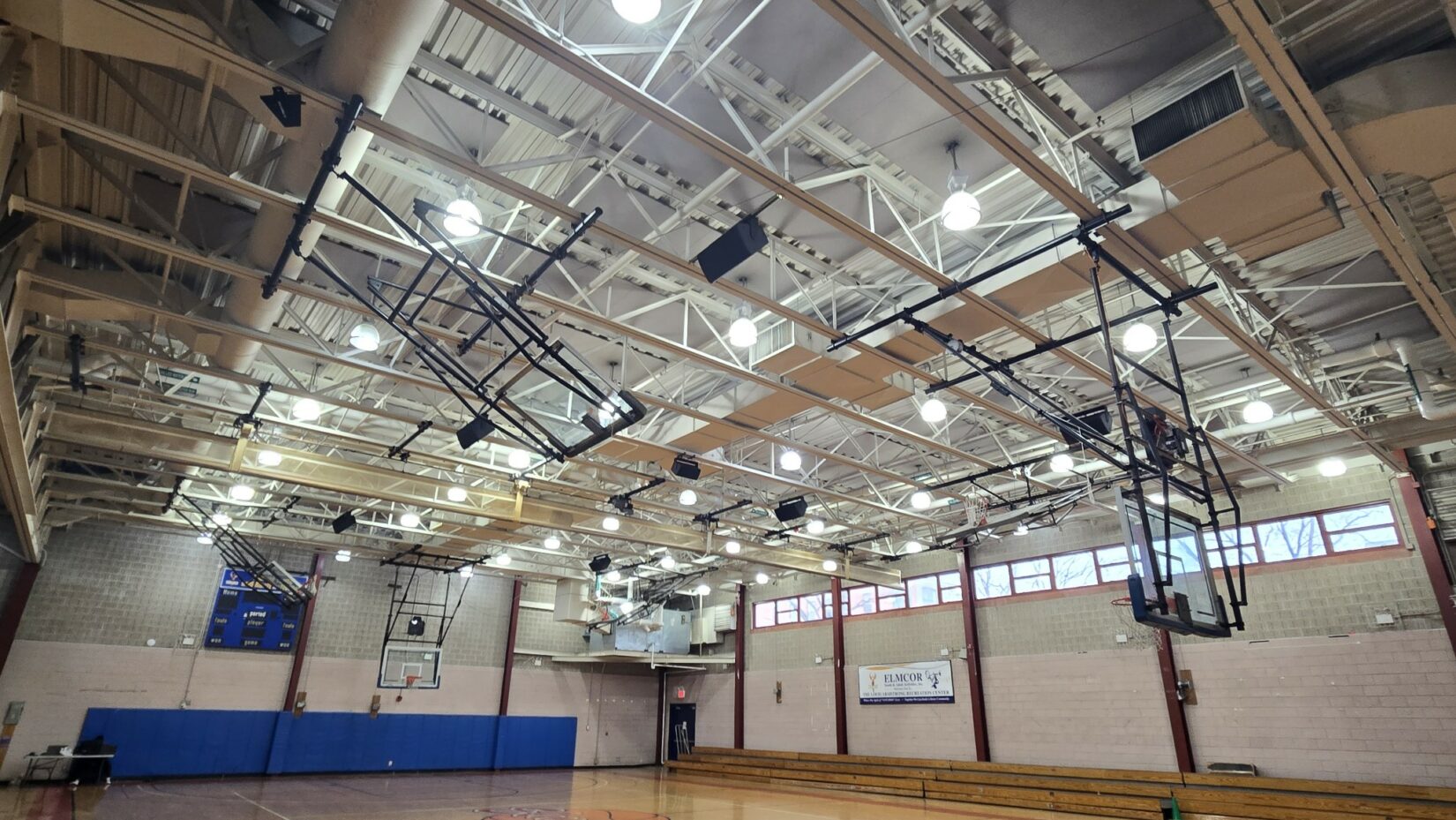 Elmcor indoor basketball court with bright lights. Basketball Gym Sound System Upgrade