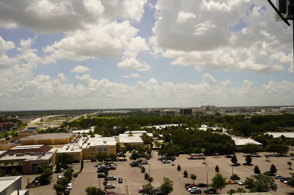 Aerial view of parking lot and green landscape.