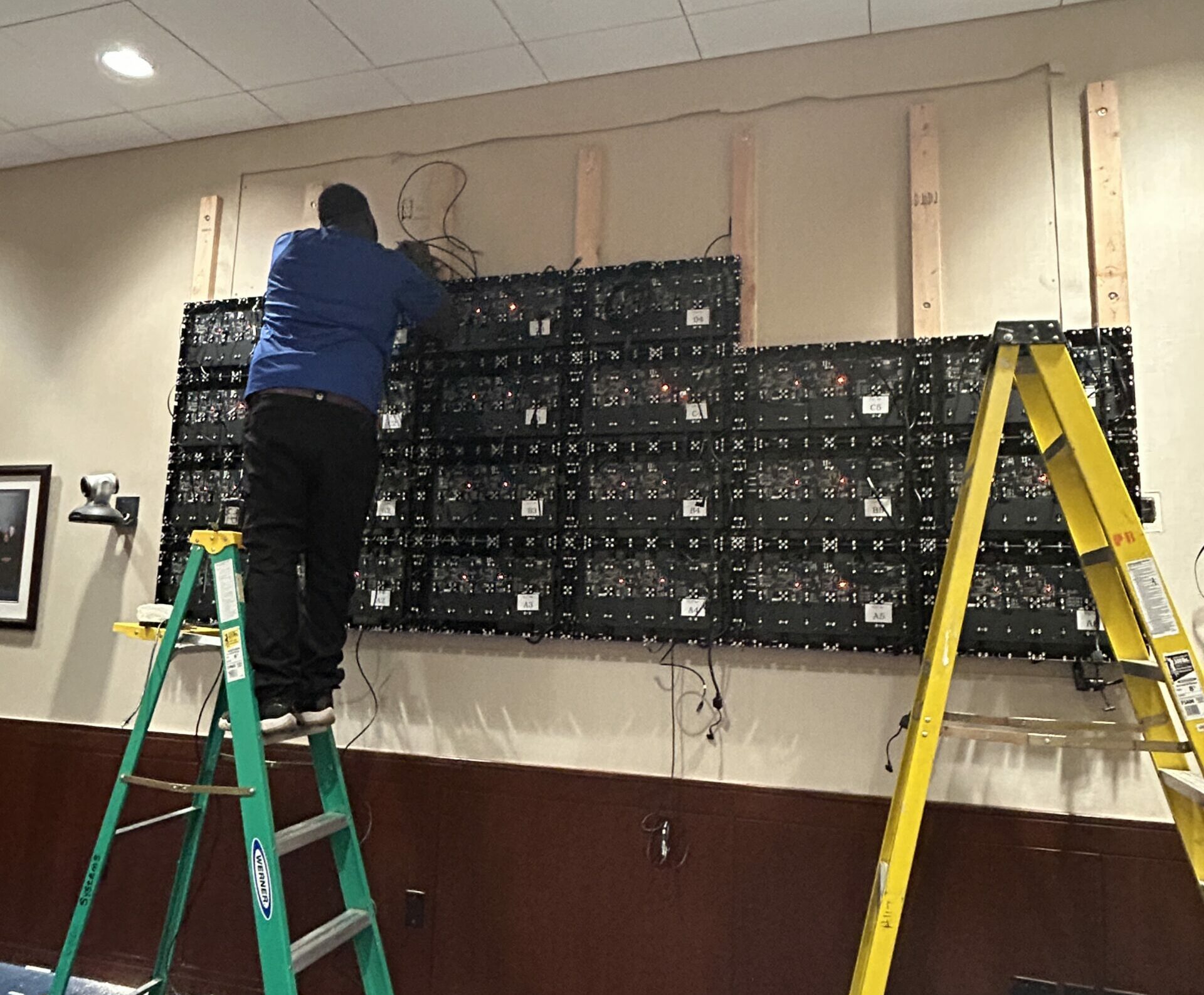 Technician installing LCD video wall panels