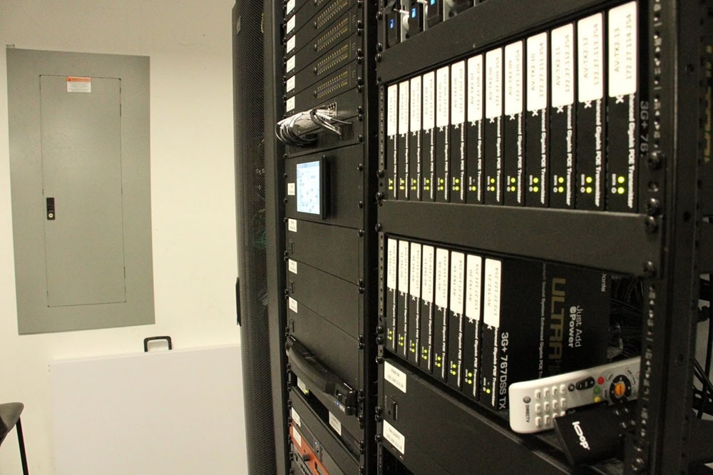 Server rack with network equipment in data center.