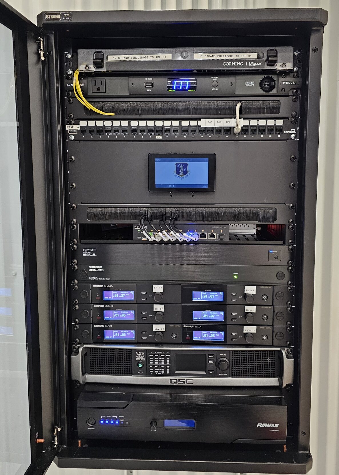 Server rack with various electronic equipment.