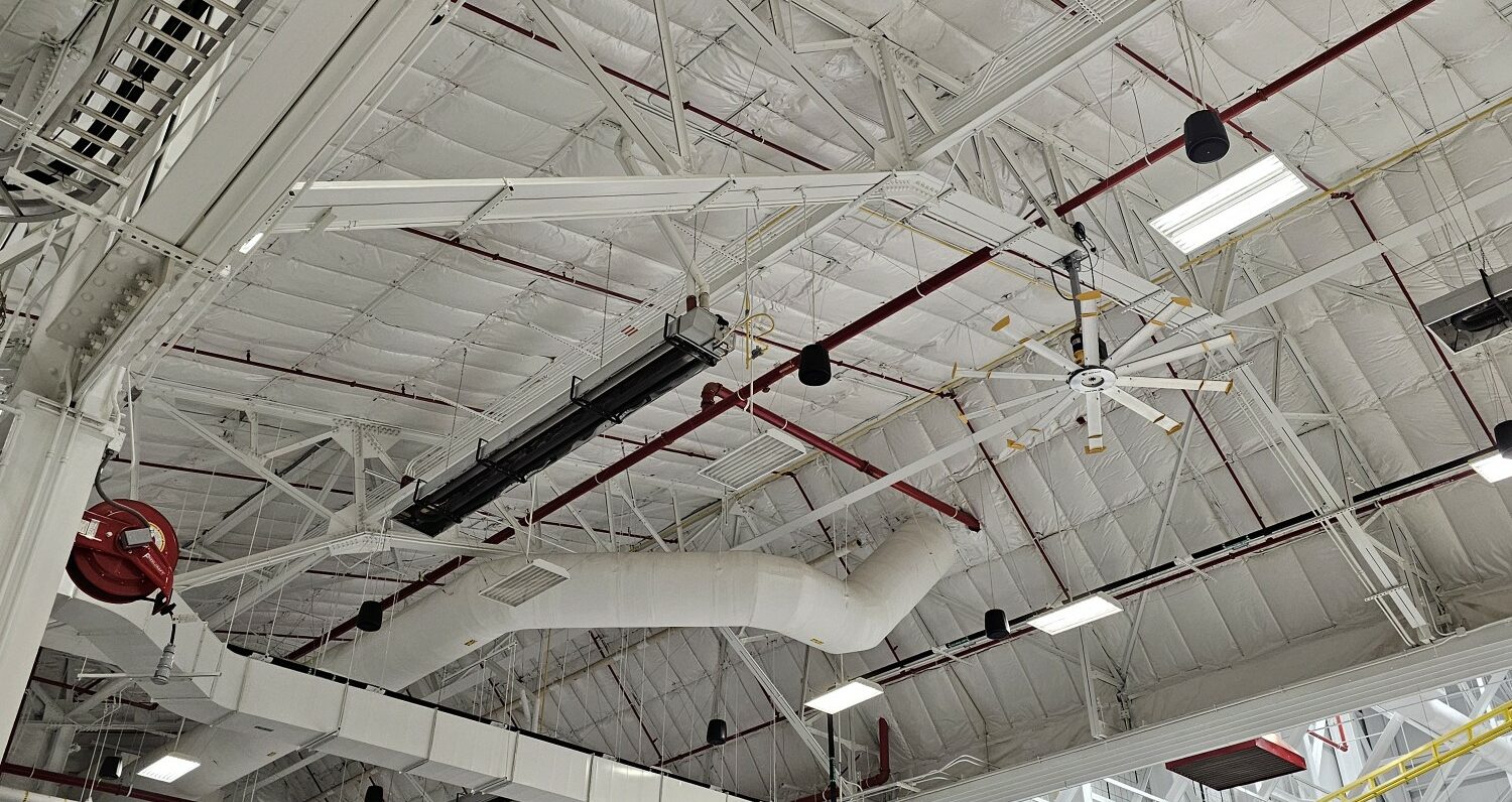 Industrial warehouse interior with equipment and pipes