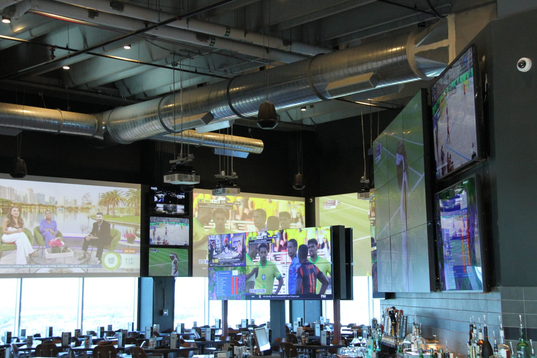 Multiple sports screens in a bar setting.
