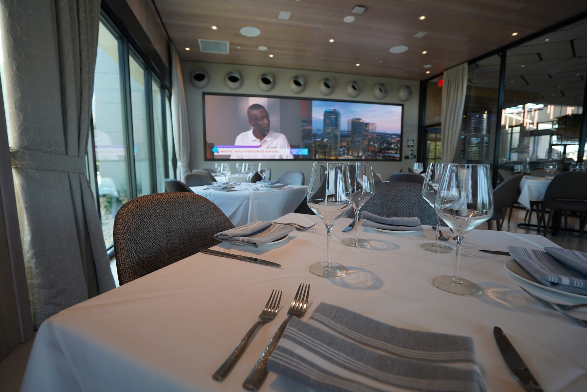 Elegant restaurant with set tables and TV screen - digital displays