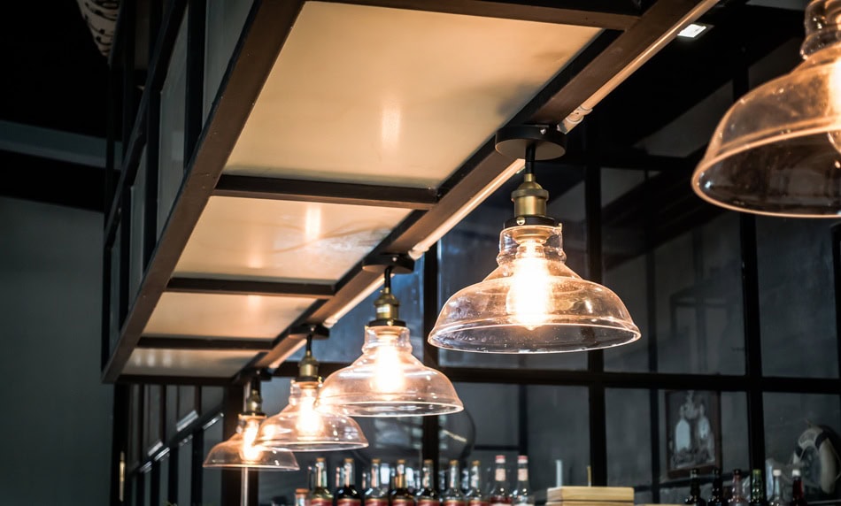 Modern industrial-style hanging light fixtures with glass shades.