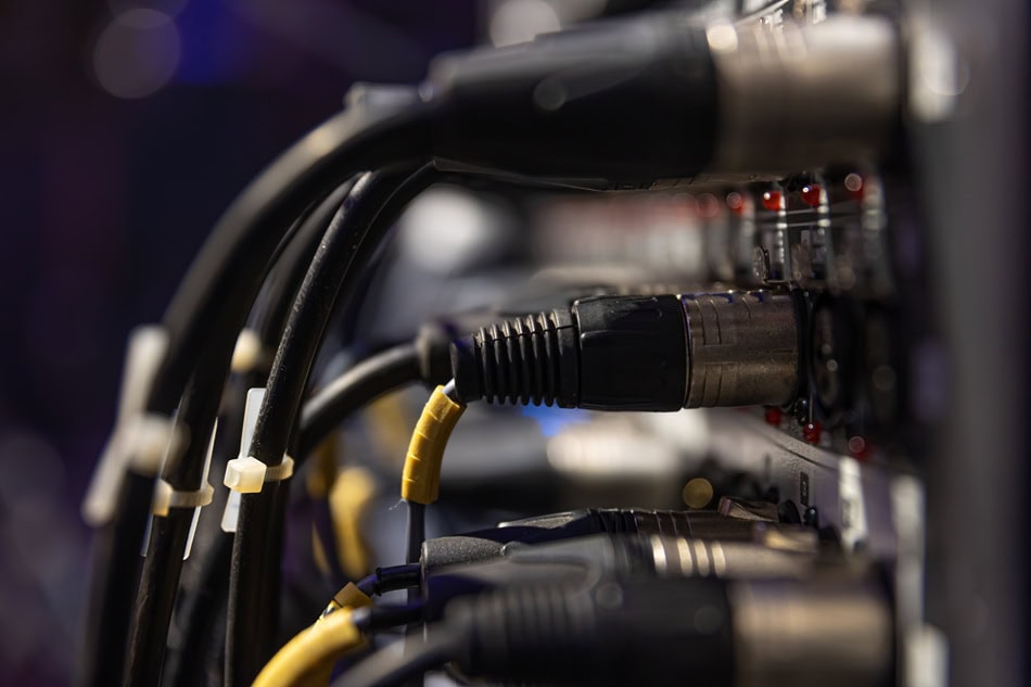 Close-up of audio cables in a sound mixer