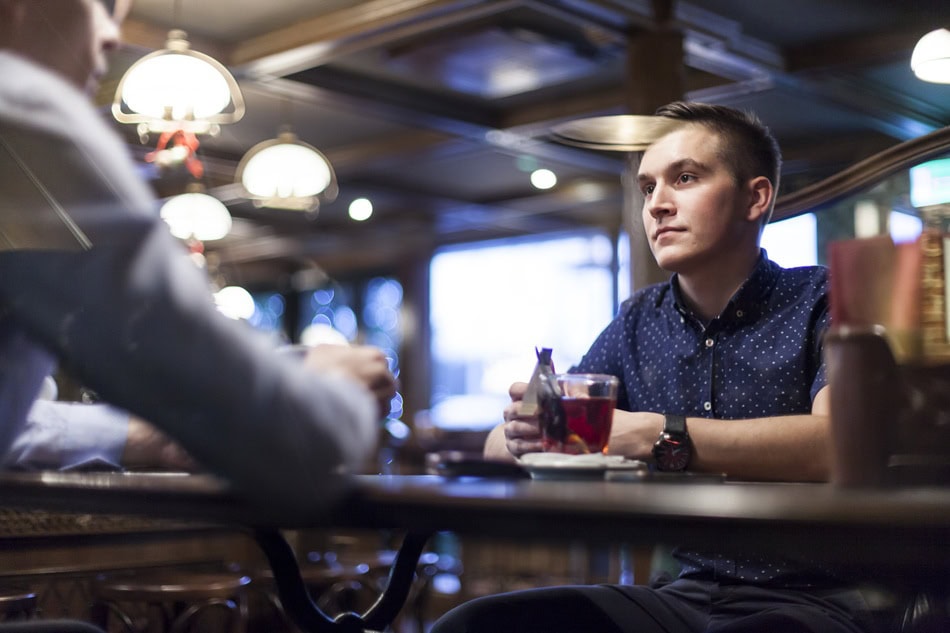 Two people talking in a cozy cafe.