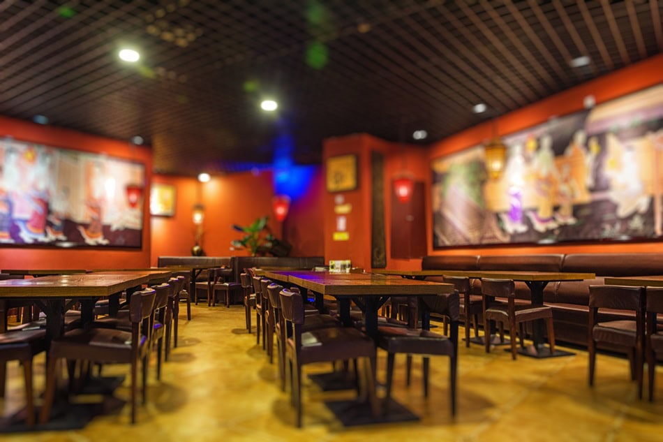 Cozy restaurant interior with wooden tables and chairs.