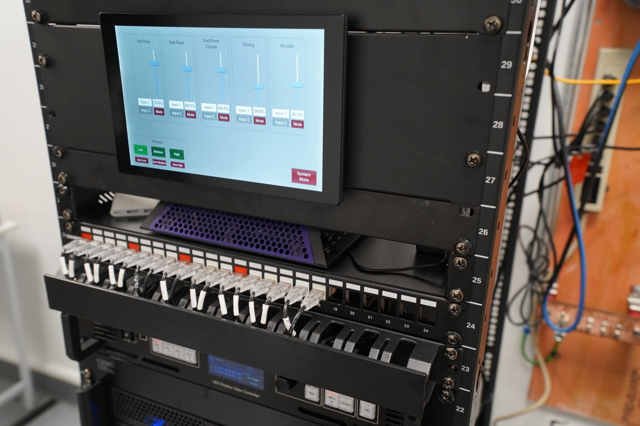 Audio equipment rack with touchscreen control panel.