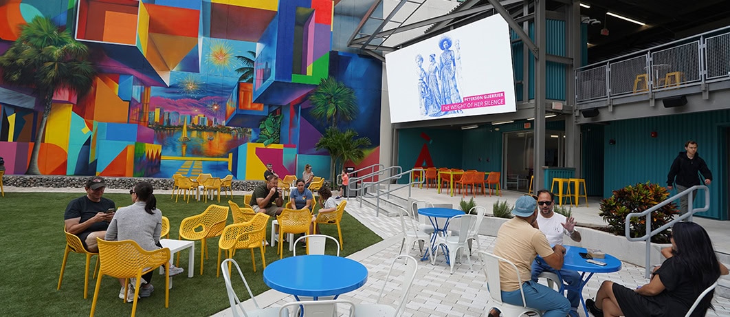 art2 orlando Outdoor cafe with colorful mural walls.