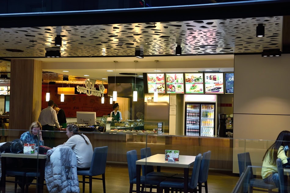 Modern fast-food restaurant interior with digital TV menus