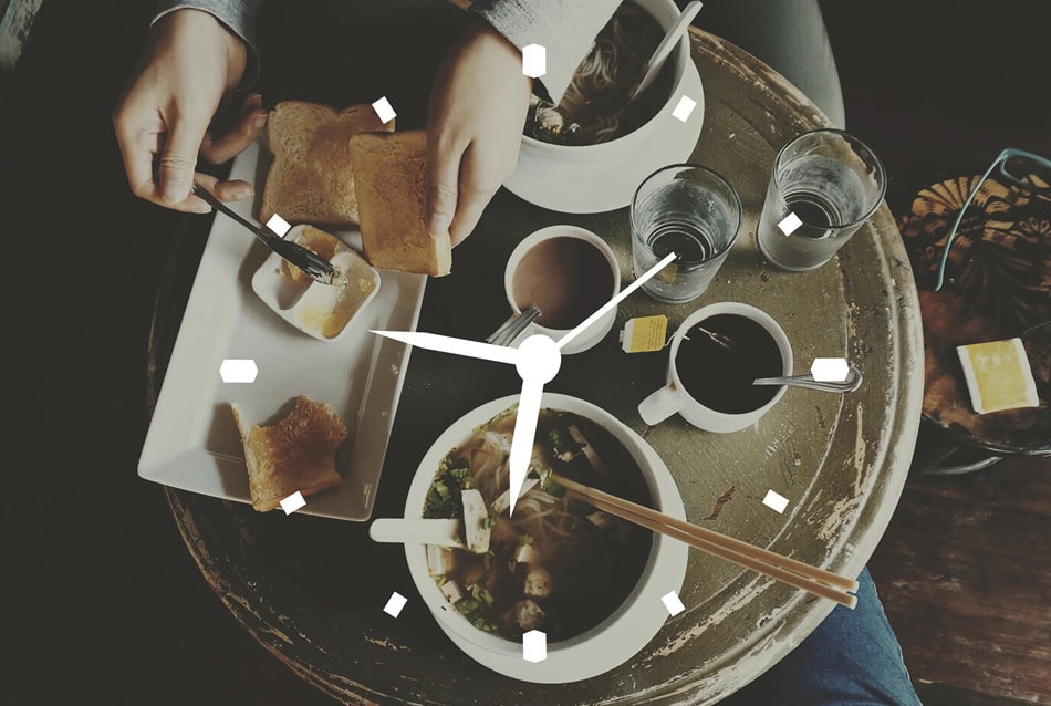Breakfast table with food and overlay clock design.