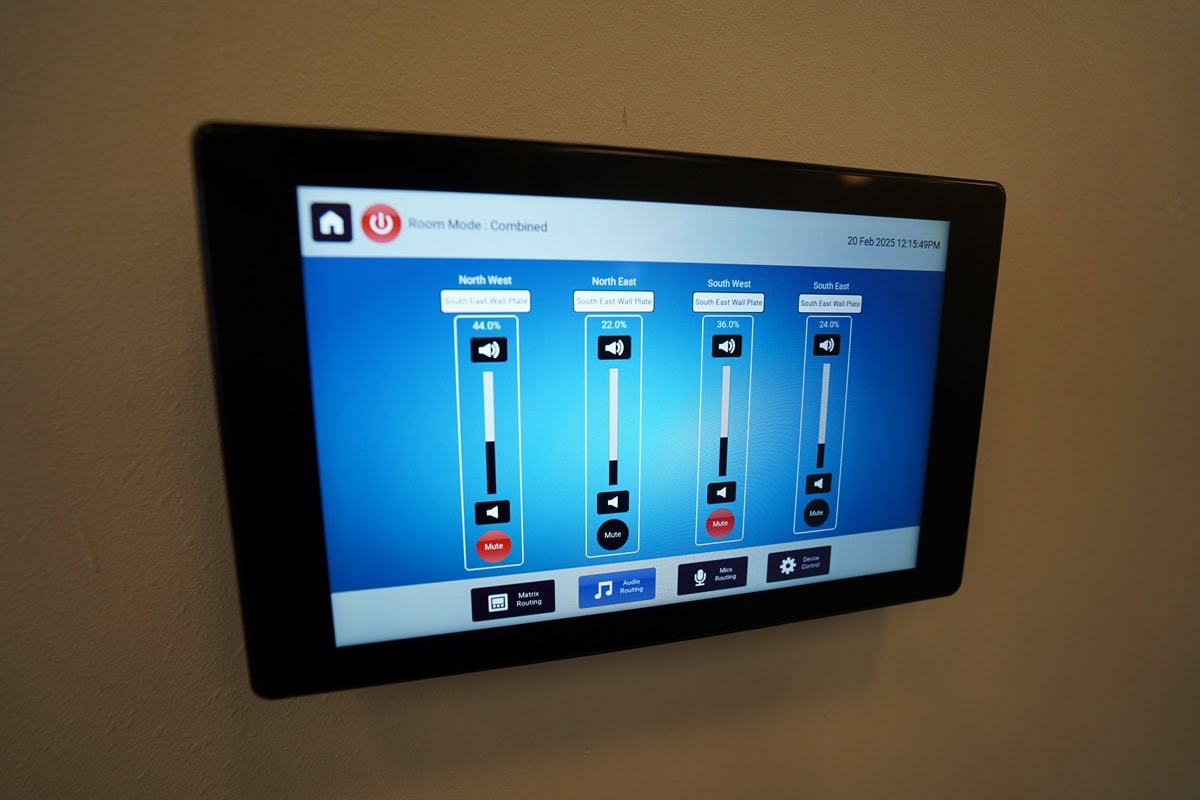 Wall-mounted control panel for room volume settings.