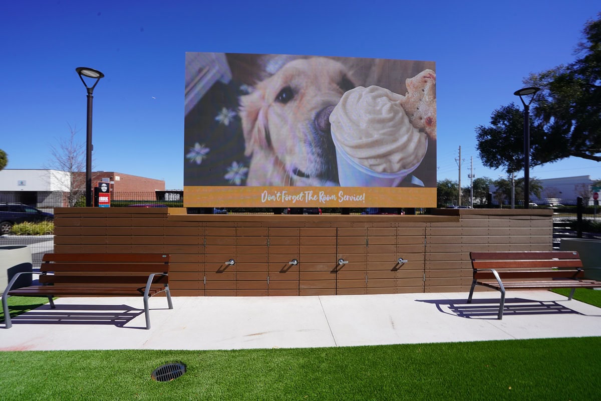 Large outdoor LED wall with dog, ice cream image.