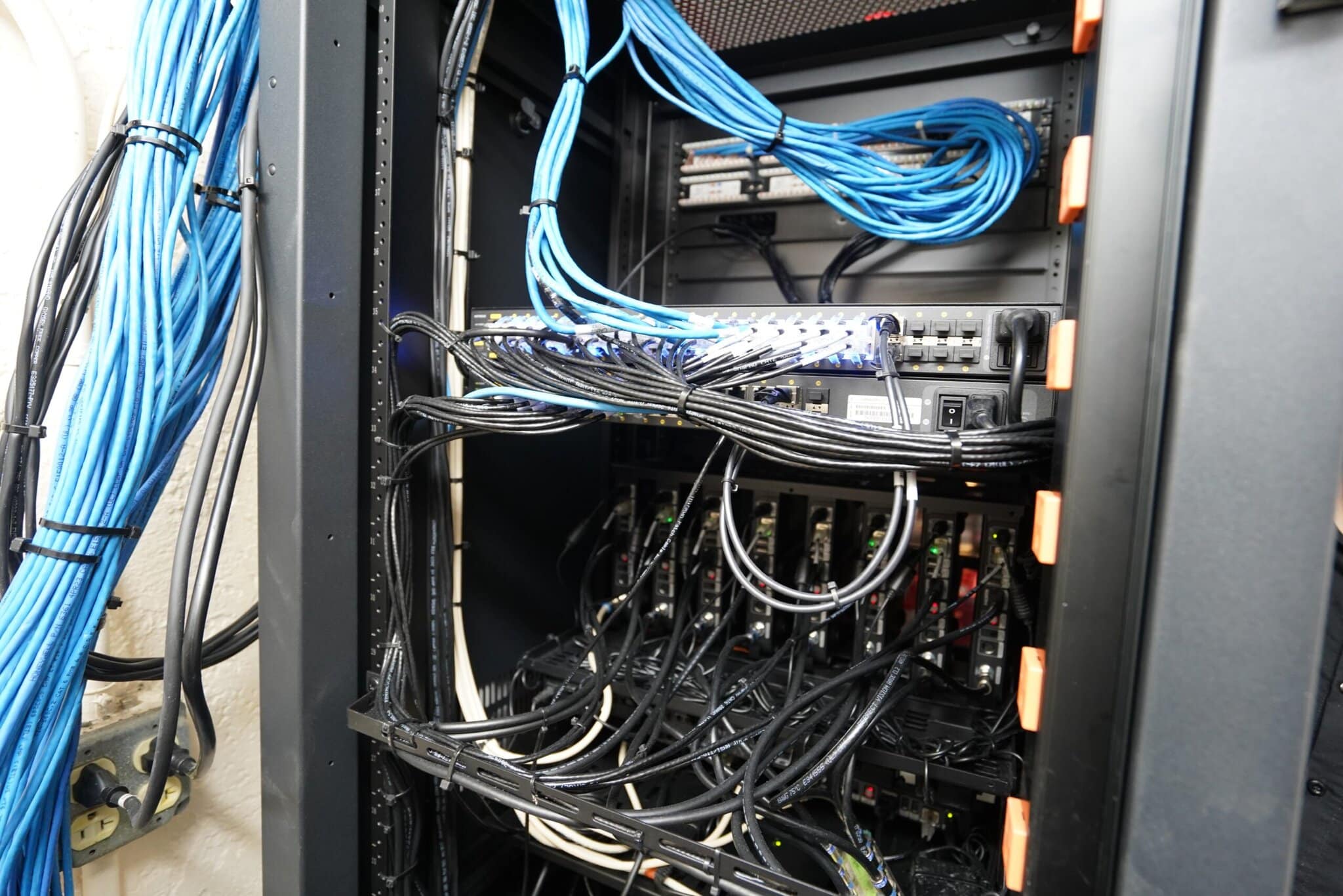 Server rack with blue and black network cables.