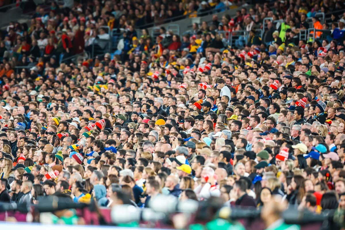 Large crowd of sports fans in stadium seats.
