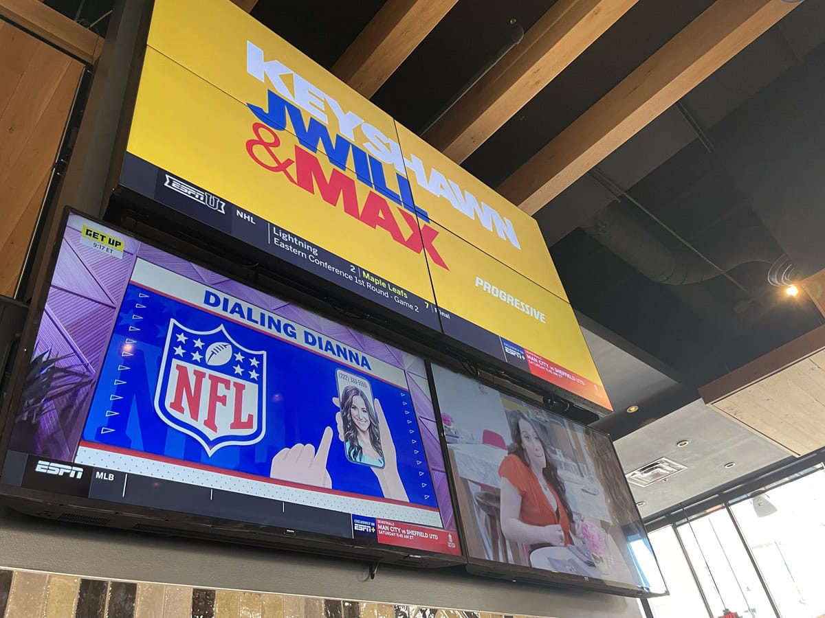 Sports news show on restaurant TV screens.